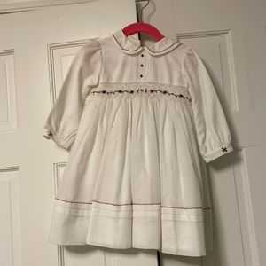 Sarah Louise smocked dress in ivory with crimson hand stitched details. 2T.